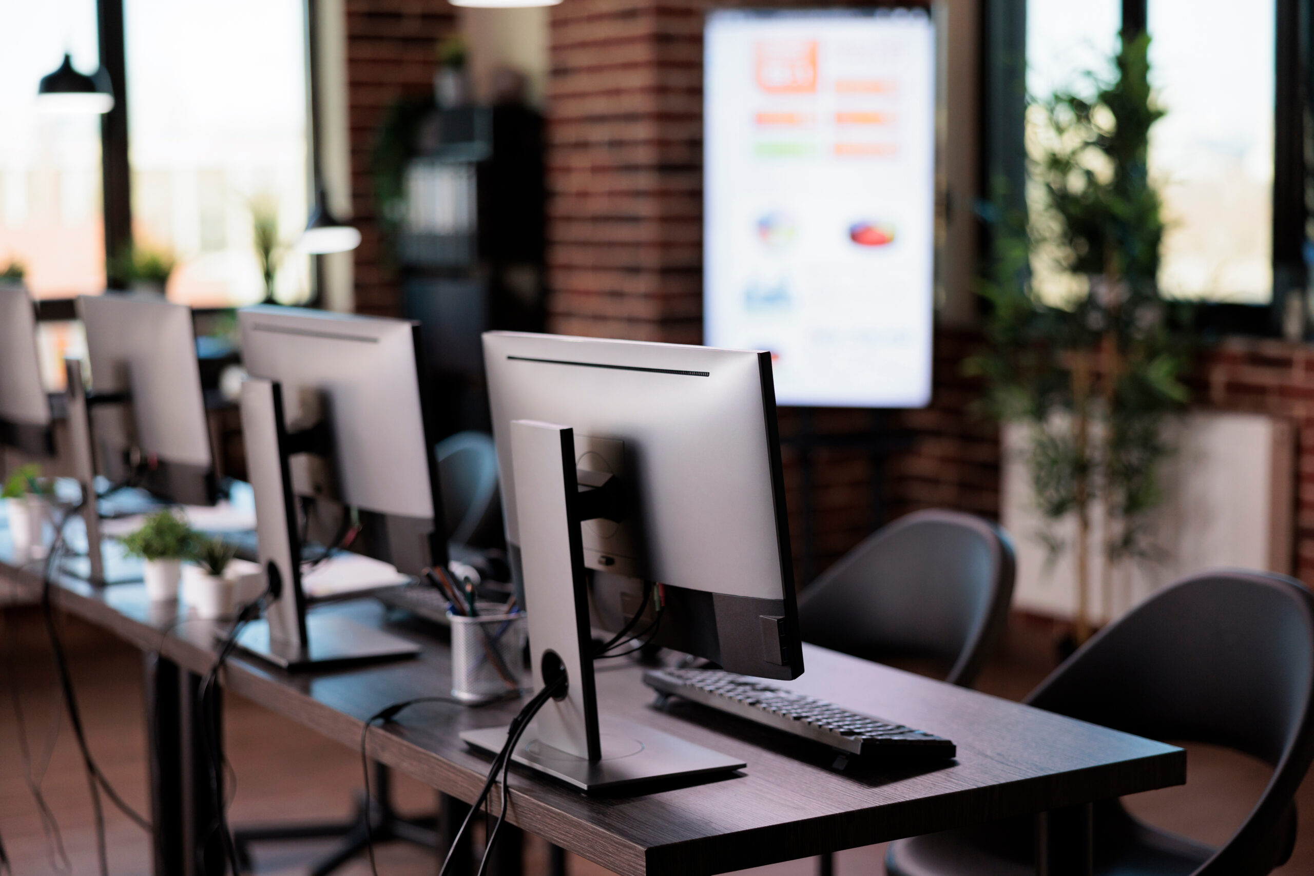 Empty call center helpdesk with multiple monitors in office